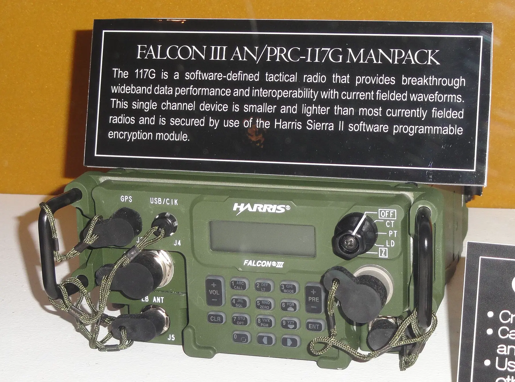 Green multiband manpack tactical radio with front-panel controls and keypad
