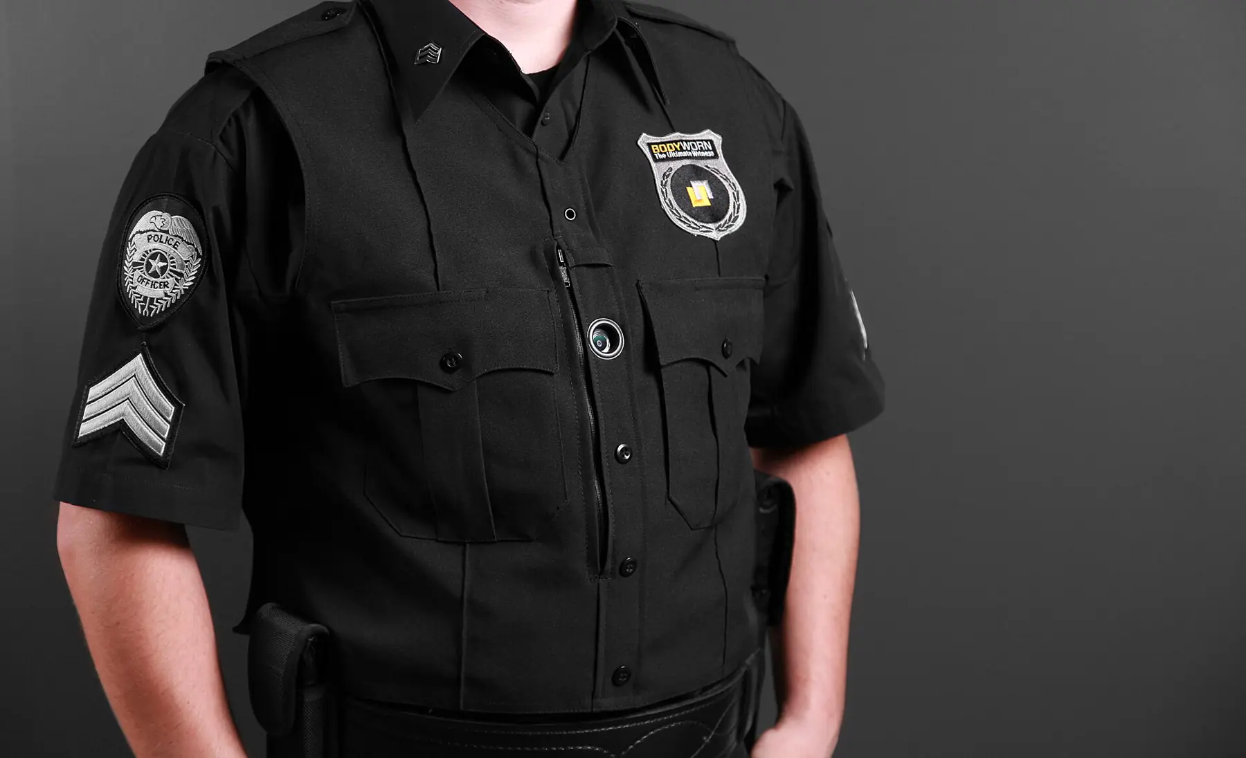 Security officer in a black uniform with a body-worn camera on the chest